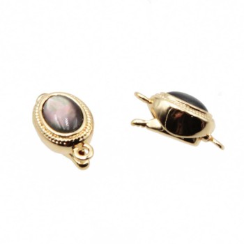 Chiusura a slitta oro con occhio di gatto nero 10x8 mm conf.1pz Chiusura a slitta oro con occhio di gatto nero 10x8 mm conf.1pz